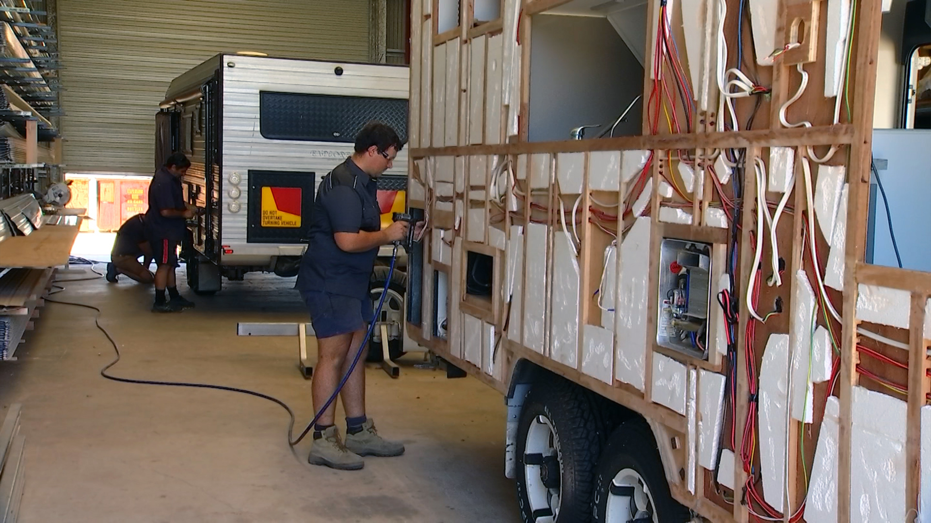 Man repairing a caravan