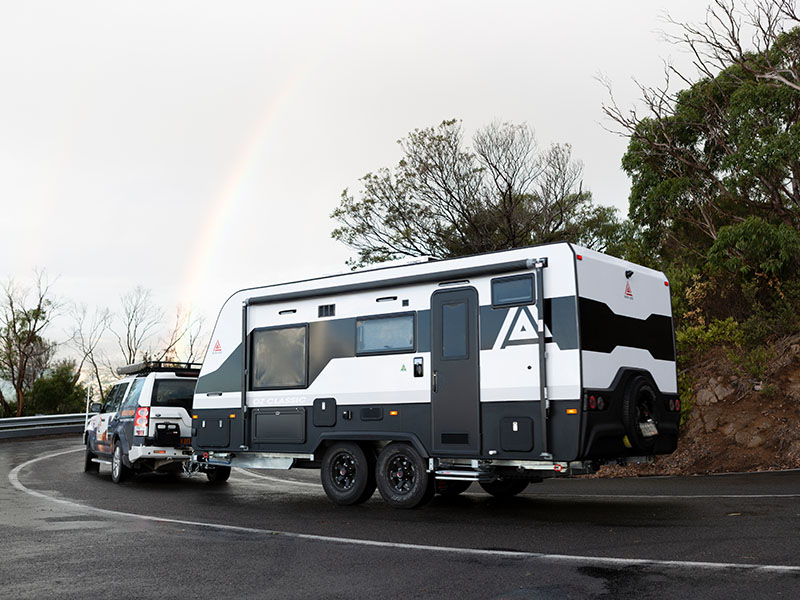 car and caravan traveling on road safely